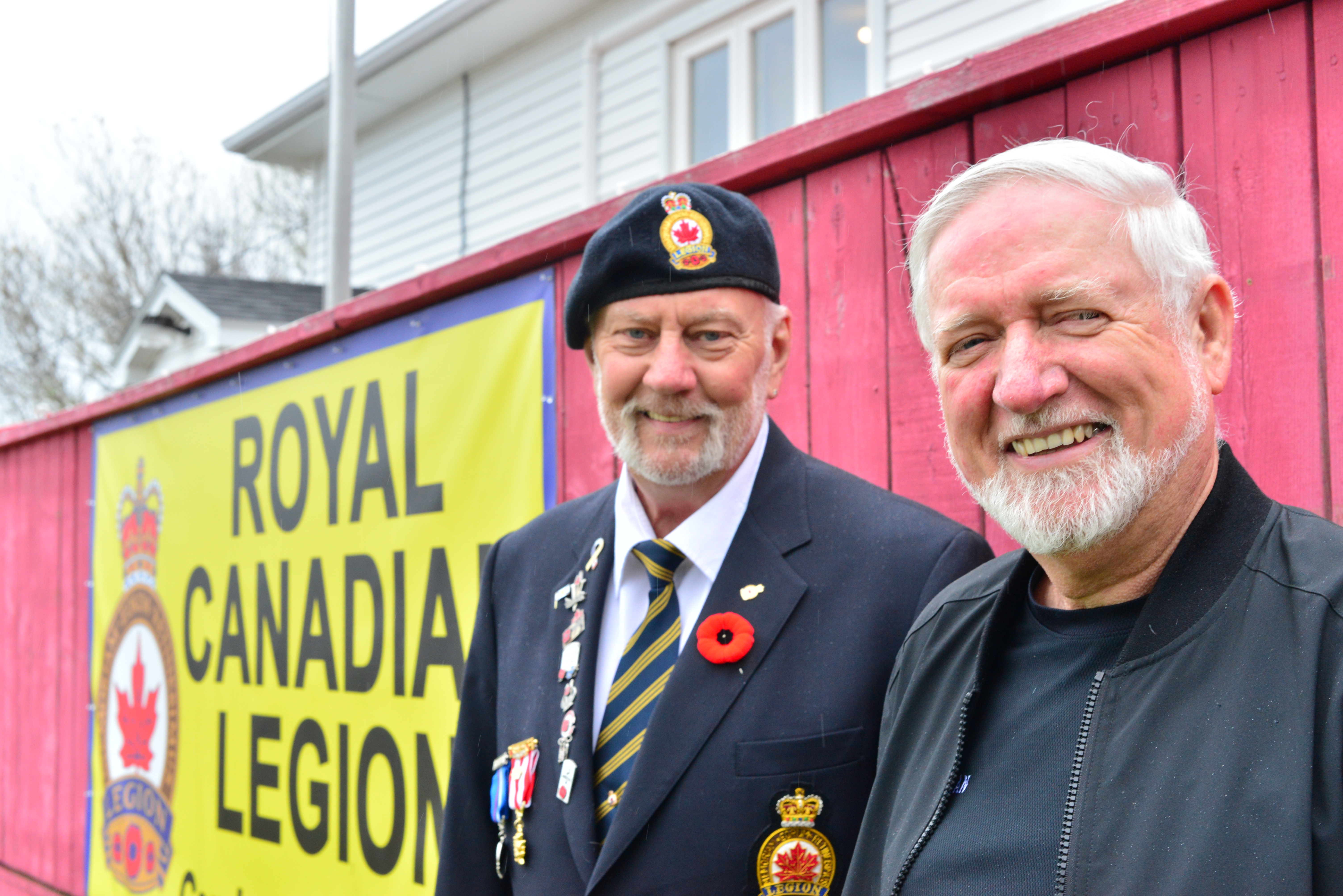 Two volunteers for Mulgrave Monte Carlo event smile in front of Royal Canadian Legion sign